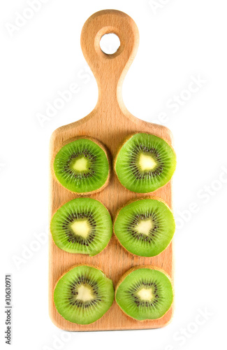 slices of kiwi on the vertical cutting board isolated over white