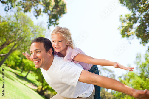 Father playing with his daughter in the park