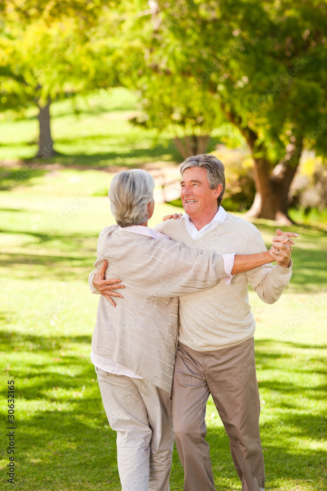 Mature couple dancing in the park Mature couple dancing in the park