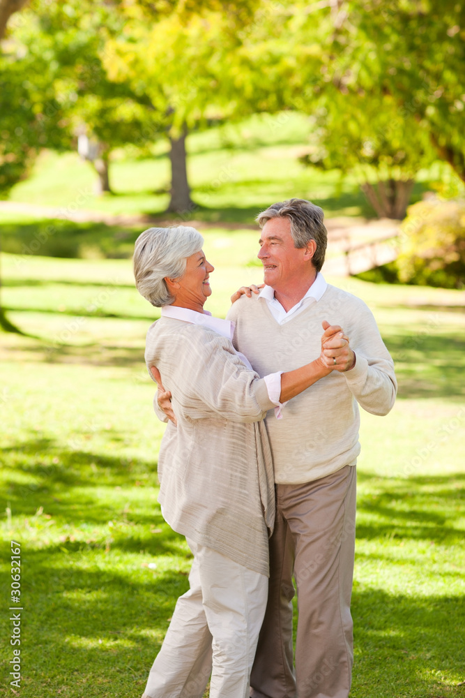 Mature couple dancing in the park Mature couple dancing in the park