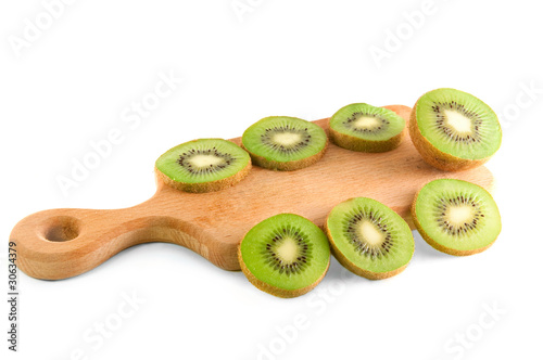 slices of kiwi on the cutting board over white