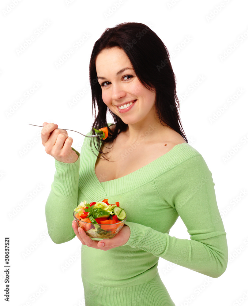 Young attractive woman eats vegetable salad Young attractive woman eats vegetable salad