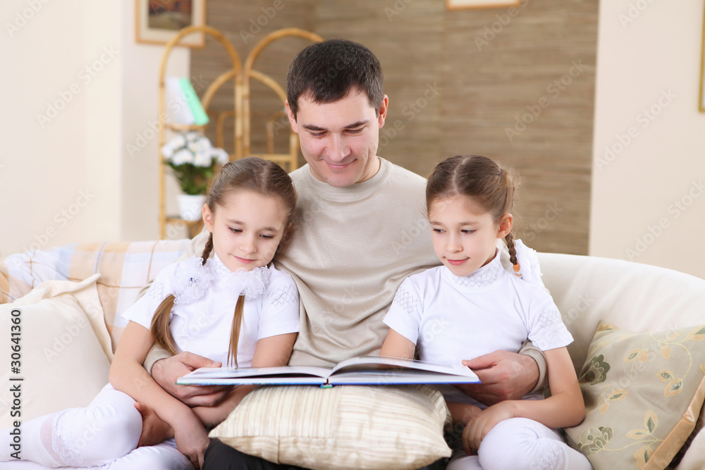 father with his daughters at home