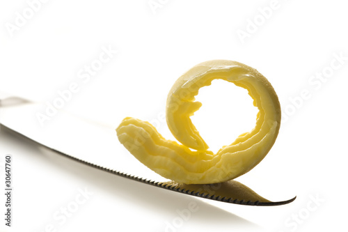Curl of butter on a knife tip