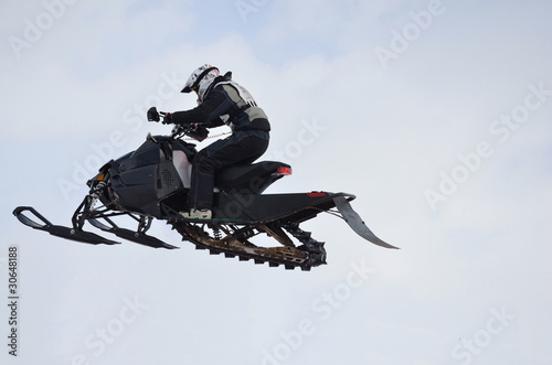 Russia, Samara. Snowmobile rider flying high air