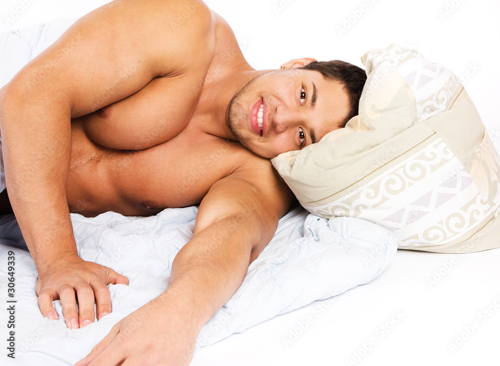 Portrait of a cheerful man relaxing in his bedroom lying on his Portrait of a cheerful man relaxing in his bedroom lying on his