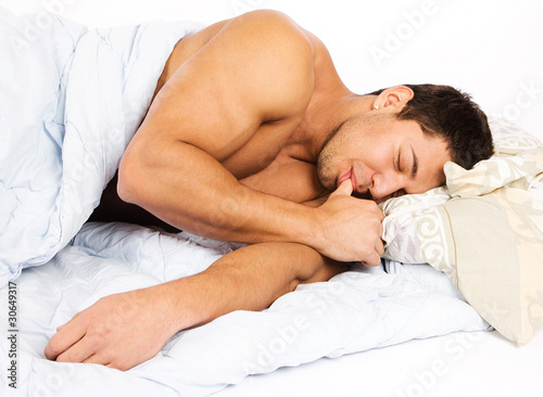 Portrait of a happy man lying on his bed at home