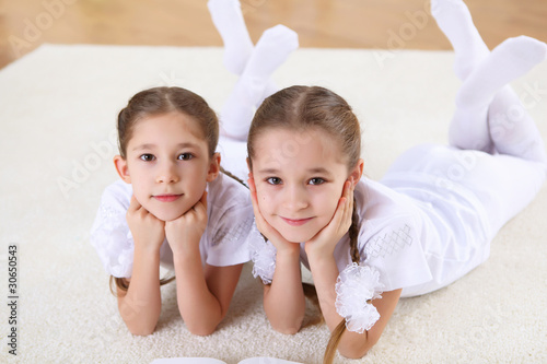 twin sisters together at home photo