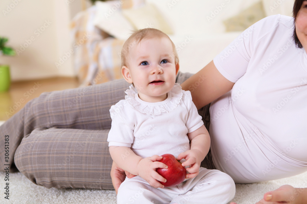 a young mother with her infant baby at home a young mother with her infant baby at home