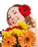 Happy young woman holding flowers.