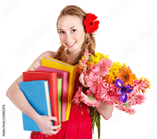 Young woman holding flowers and books.