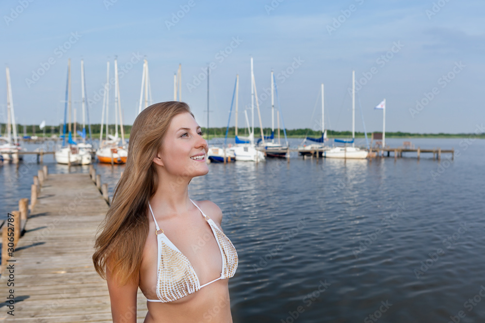 Attractive young woman near the yachts
