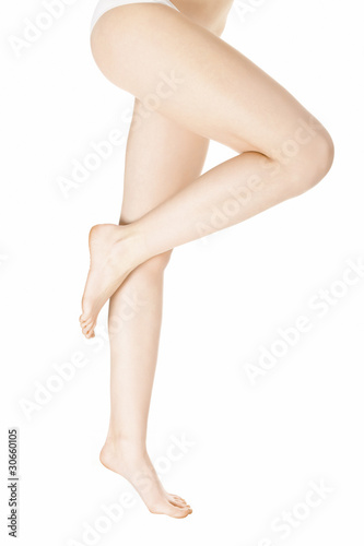 Slender and long beautiful female legs, isolated on white