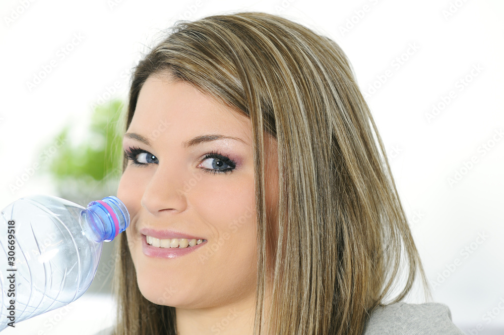 young beautiful woman with a bottle of water young beautiful woman with a bottle of water