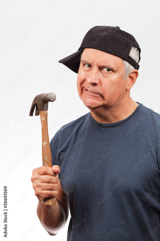Middle Age Man with a Hammer and Angry Expression Middle Age Man with a Hammer and Angry Expression