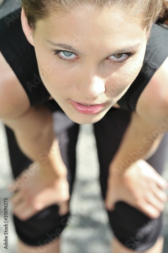 Young woman relaxing after running photo