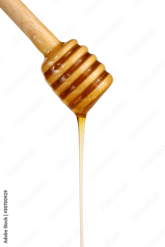 honey flowing down from a wooden stick honey flowing down from a wooden stick