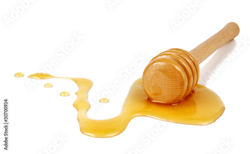 honey flowing down from a wooden stick