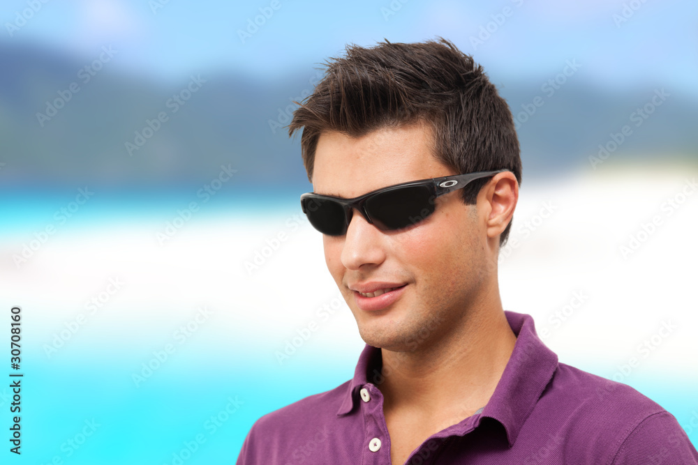 Young man smiling on the beach Young man smiling on the beach