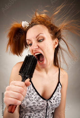 Housewife singing with a hairbrush