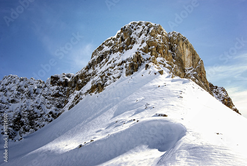 Mountain peak with snow and blue sky