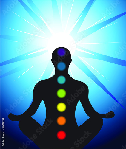Male silhouette meditating with chakra