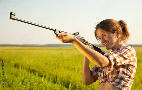 girl  aiming a pneumatic rifle