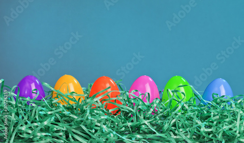 Easter Eggs in Green Grass Against a Blue Background