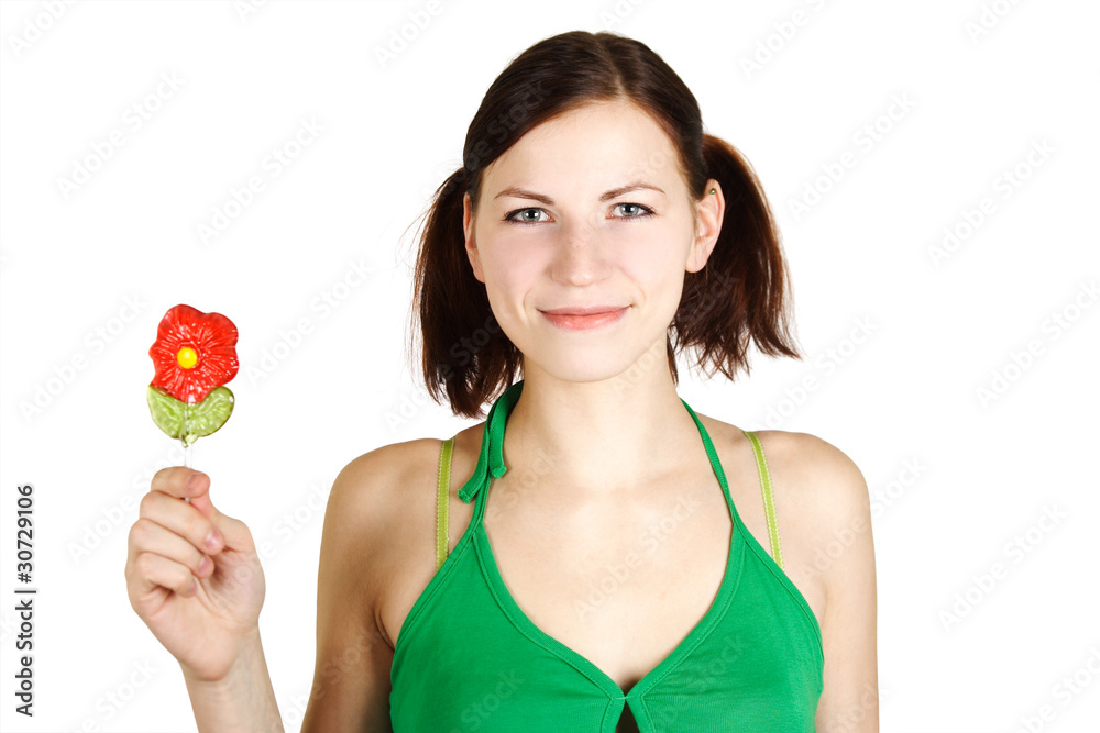 young girl in green shirt holding flower lollipop and smiling, i young girl in green shirt holding flower lollipop and smiling, i