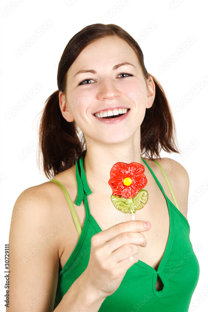 young girl in green shirt holding flower lollipop and smiling, i young girl in green shirt holding flower lollipop and smiling, i