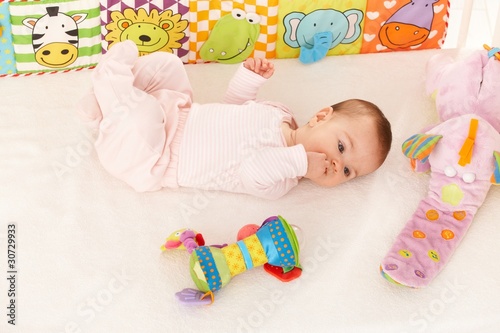 Baby girl looking at colorful toy