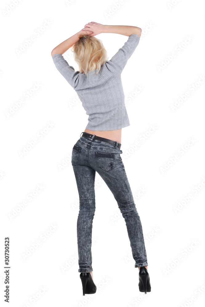 Young woman dancing. Rear view.