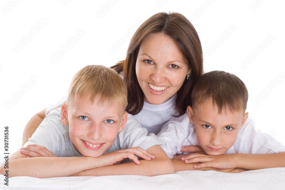 smiling mom sitting at the desk with sons smiling mom sitting at the desk with sons