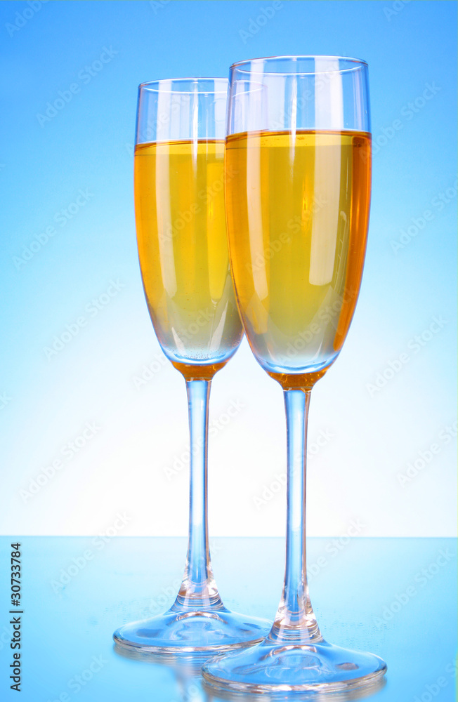 Glass with champagne on blue background Glass with champagne on blue background