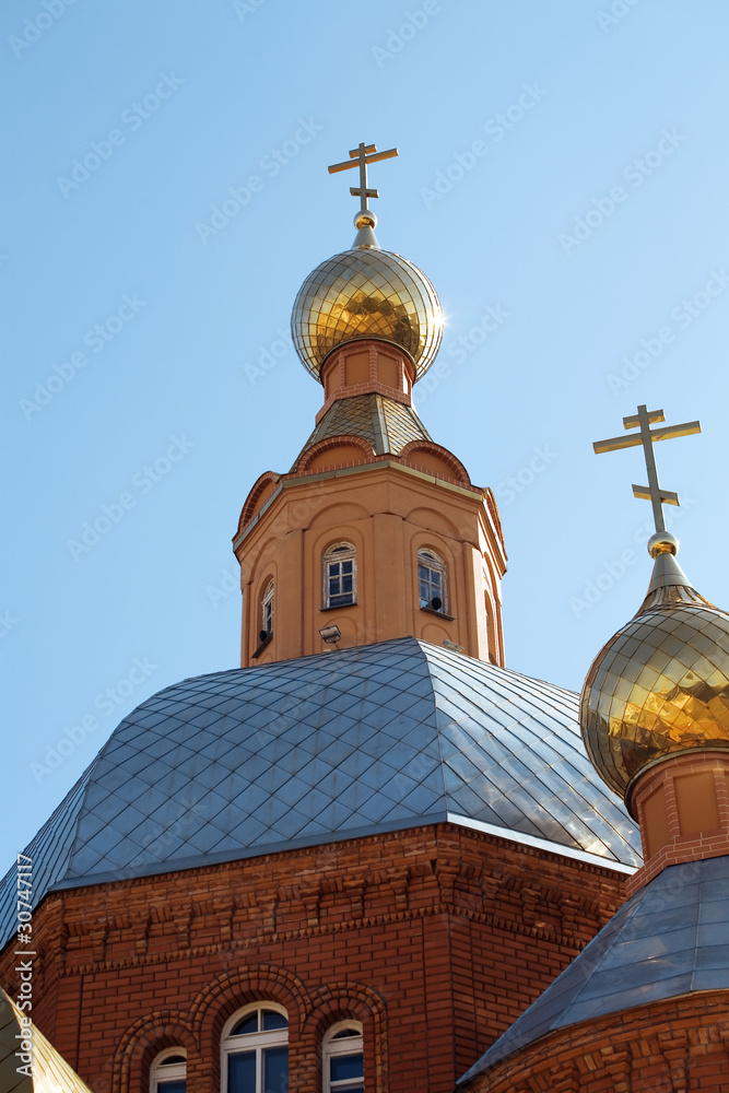 Golden domes of Christian church against the blue sky