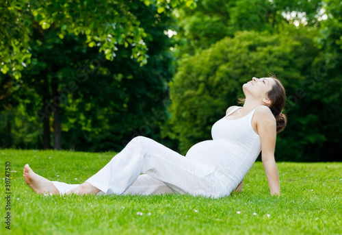 Beautiful pregnant woman relaxing in the park © sborisov