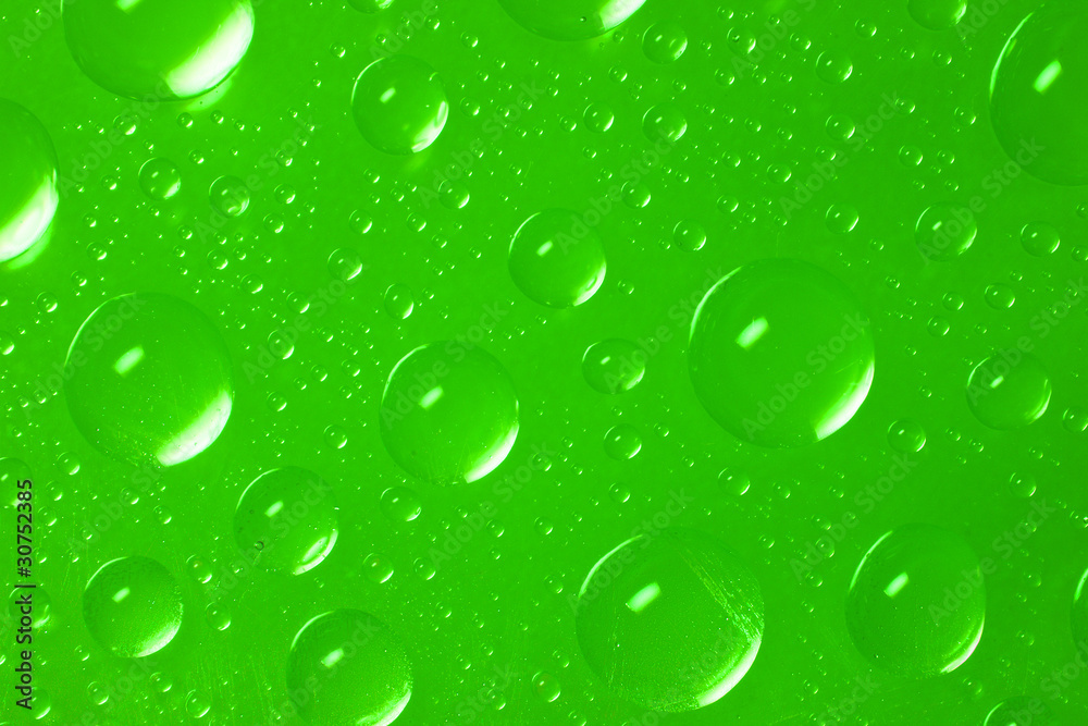 drops of water on green background