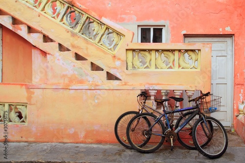 bicycles on grunge tropical Caribbean orange facade