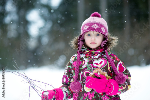 Winter portrait of beauty little girl in colorful clothes