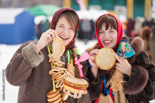 Women  tasting pancake  during  Shrovetide photo