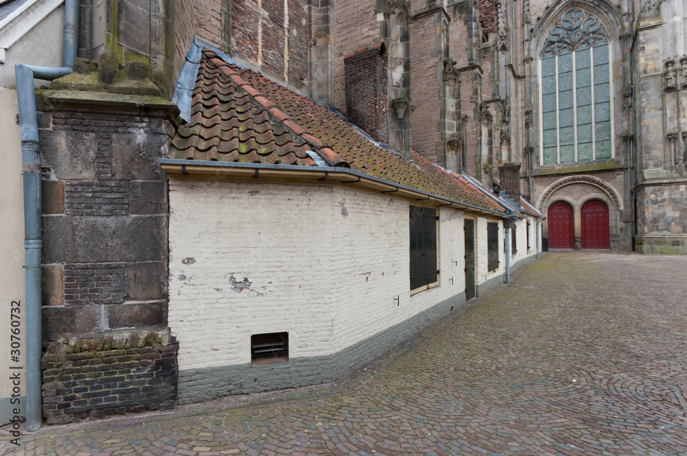 small houses against old church