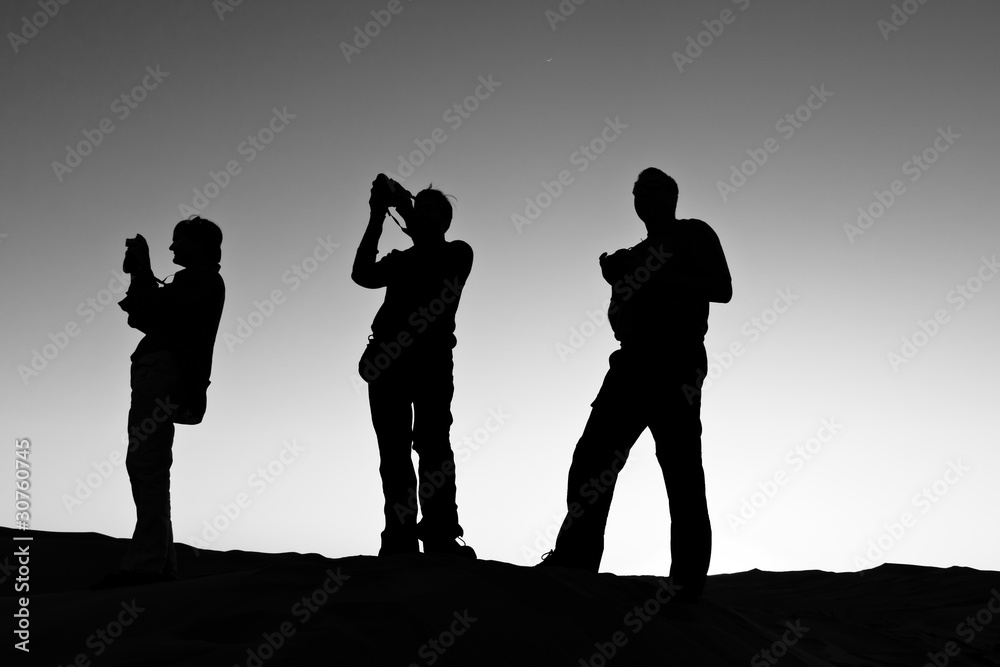 Silhouette of Three People Photographing