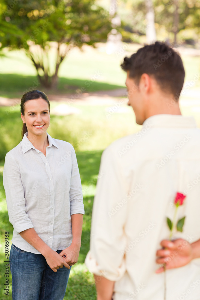 Man offering a rose to his girlfriend Man offering a rose to his girlfriend