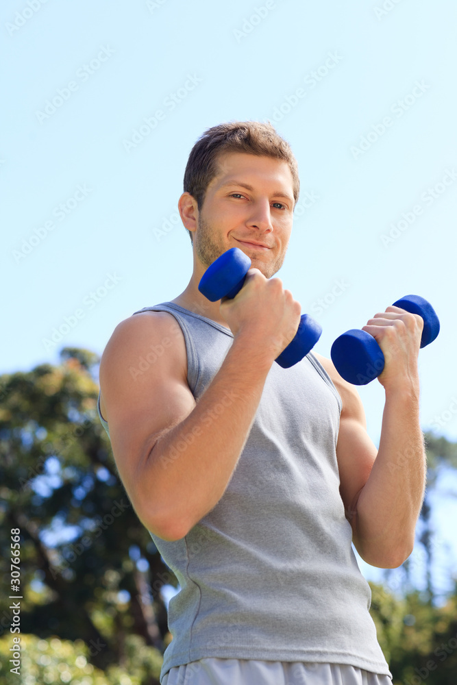 Young man doing his exercises in the park Young man doing his exercises in the park