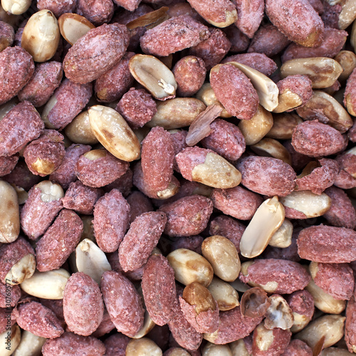 Roasted and salted groundnuts closeup, natural background