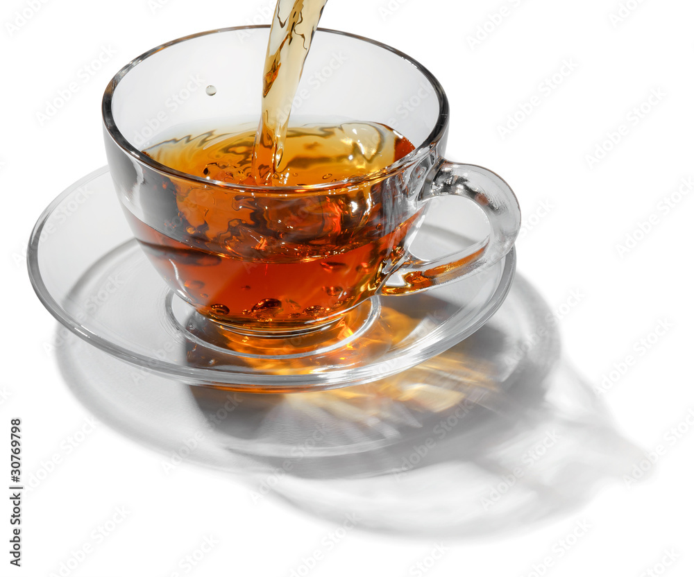 Tea flowing in cup Tea flowing in cup