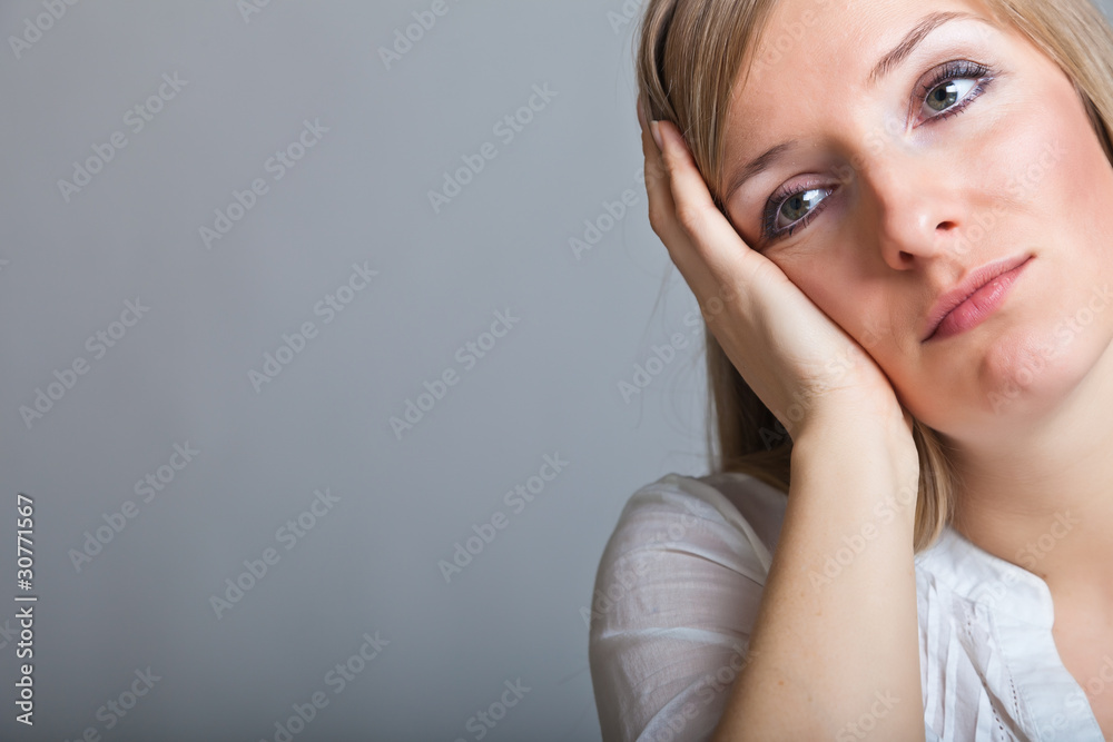 Depressed, sad woman on neutral background Depressed, sad woman on neutral background