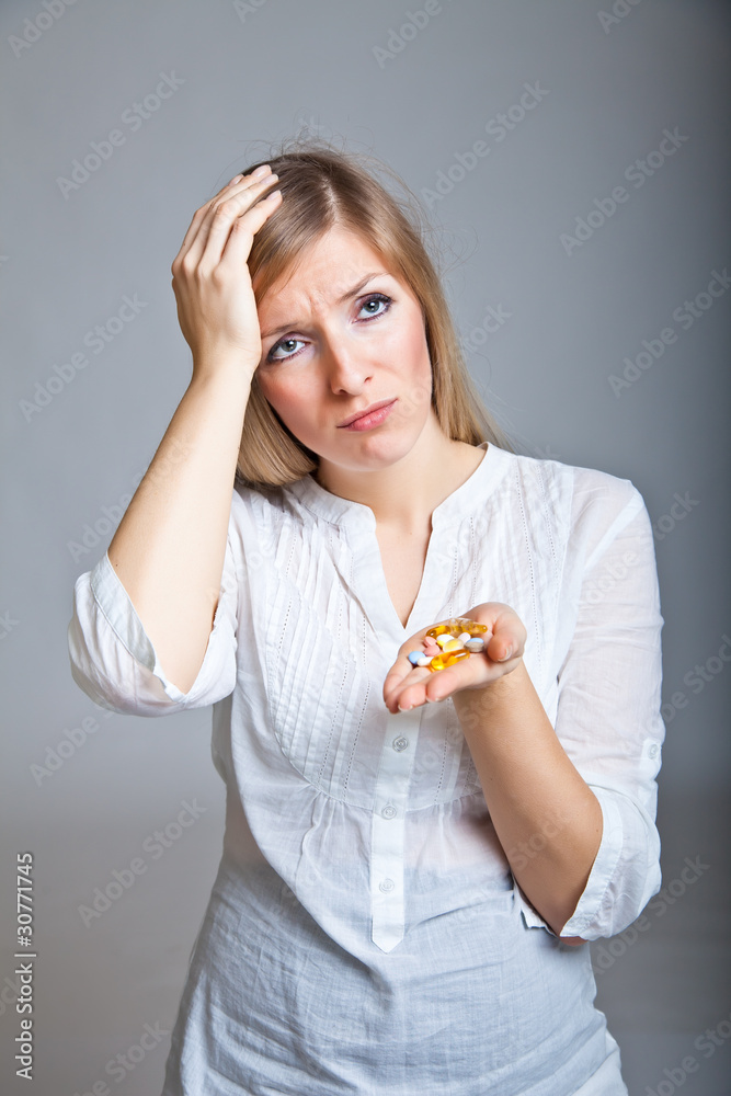 Woman holding pharmaceuticals on neutral bg Woman holding pharmaceuticals on neutral bg
