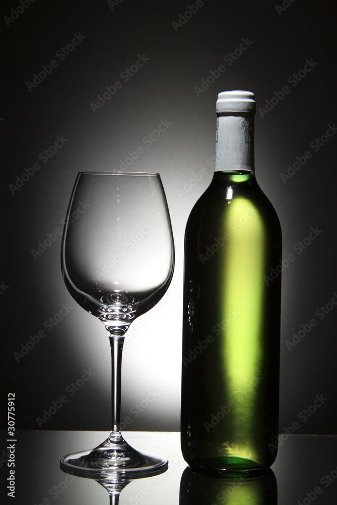 Bottle of white wine and empty wine glass Bottle of white wine and empty wine glass