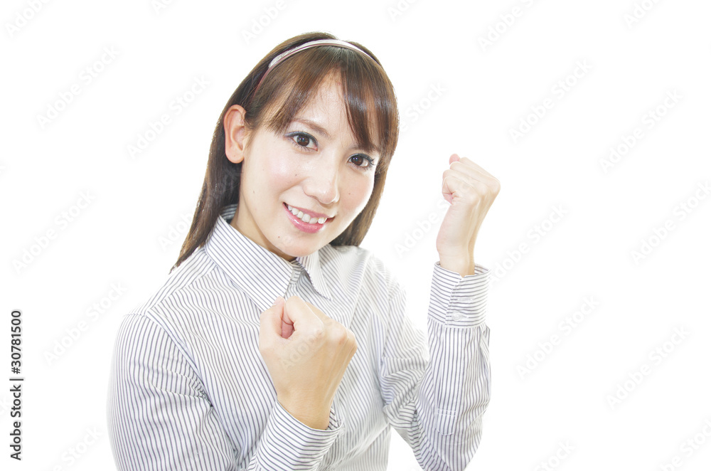 ガッツポーズの笑顔で元気な女性 ガッツポーズの笑顔で元気な女性